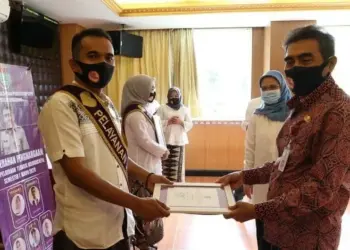 PIAGAM PENGHARGAAN: Kepala Disdukcapil Kabupaten Tangerang Syafrudin didampingi Sekdisdukcapil Yeni Suryani, menyerahkan piagam penghargaan dan uang kadedeuh kepada salah satu pegawai pelayanan Top 9 Non PNS terbaik, di sebuah rumah makan. (FAJAR ADITYA KUSUMA/SATELIT NEWS)