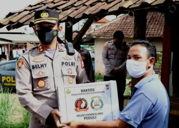 Kapolres Pandeglang, AKBP Belny Warlansyah sedang memberikan bantuan kepada penyandang disabilitas, di kediamannya, Kamis (18/11/2021). (ISTIMEWA)