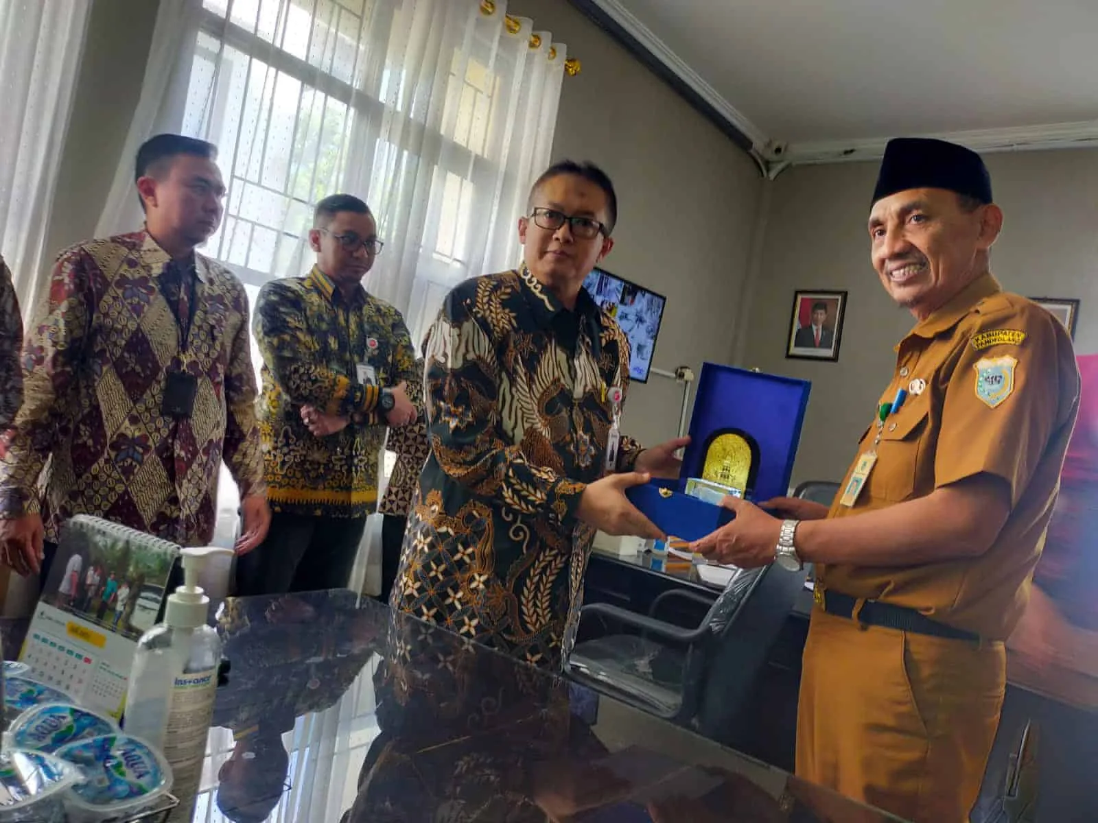 Kepala Bapenda Pandeglang, Tatang Muhtasar sedang menerima cendermata dari pihak Bank Banten, di kantor Bapenda setempat, Selasa (7/6/2022). (ISTIMEWA)