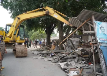 ALAT BERAT: Situasi di Pasar Pisangan, Kelurahan Bencongan, Kecamatan Kelapa Dua, Senin (13/6). Terlihat sebuah alat berat yang dibawa Satpol PP Kabupaten Tangerang, sedang melakukan pembongkaran terhadap bangunan semi permanen yang menempati lahan pemerintah. (ALFIAN HERIANTO)