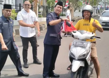 Sekretariat Dewan (Sekwan) Pandeglang dan jajarannya, bagikan bendera ke pengguna jalan di sekitaran Gedung DPRD setempat, Rabu (9/8/2023). (FAHRIE/SATELITNEWS.COM)