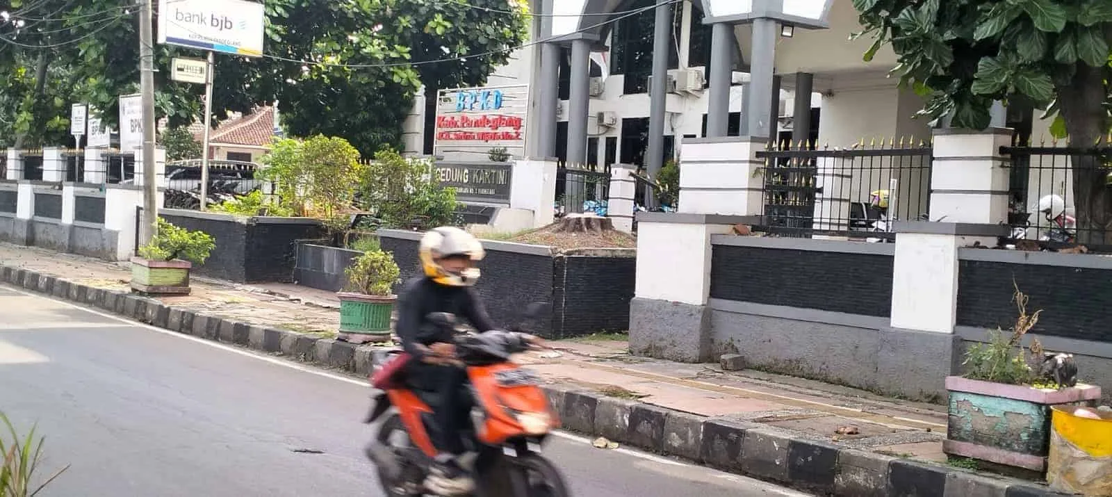 Seorang pengendara motor, melintas di depan kantor BPKD Kabupaten Pandeglang, Kamis (19/10/2023). (FAHRIE/SATELITNEWS.COM)