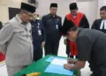 Sekda Pandeglang Ali Fahmi Sumanta, didampingi Kepala BKPSDM Kabupaten Pandeglang Didin Pahrudin dan beberapa jajarannya, menyaksikan penandatanganan Berita Acara Pelantikan (BAP), Jumat (27/12/2024). (ISTIMEWA)